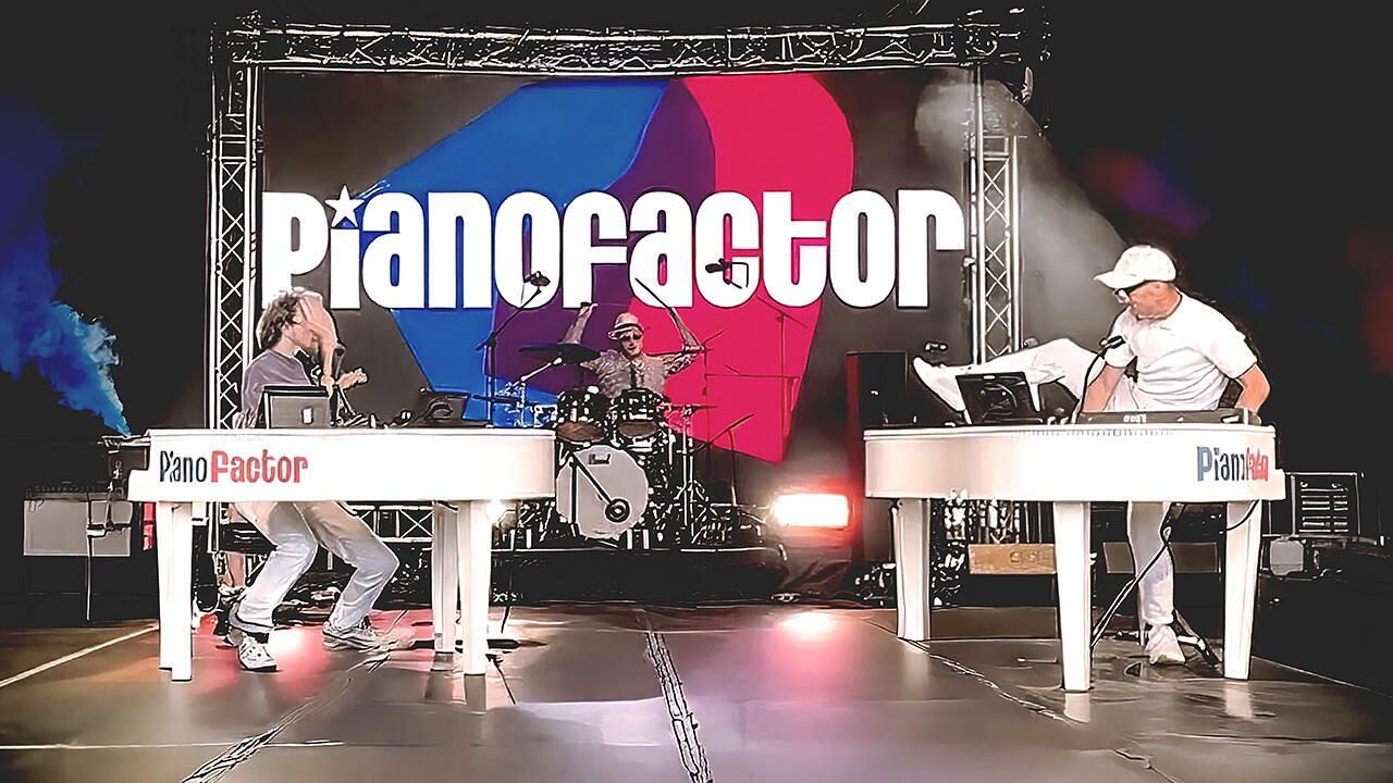 Crowd surrounding duelling pianos performers enjoying an interactive live music show