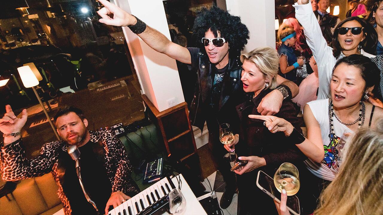 Piano entertainer interacting with guests during a live pop-up piano bar performance