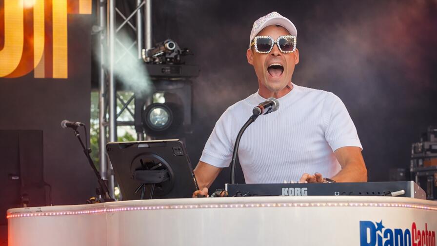 Guests singing and engaging with a live piano performer