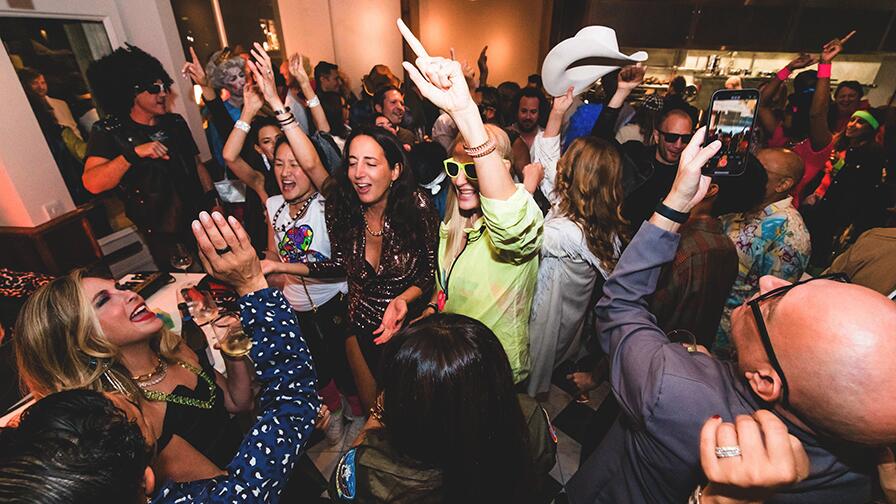 Pop-up piano entertainer surrounded by guests